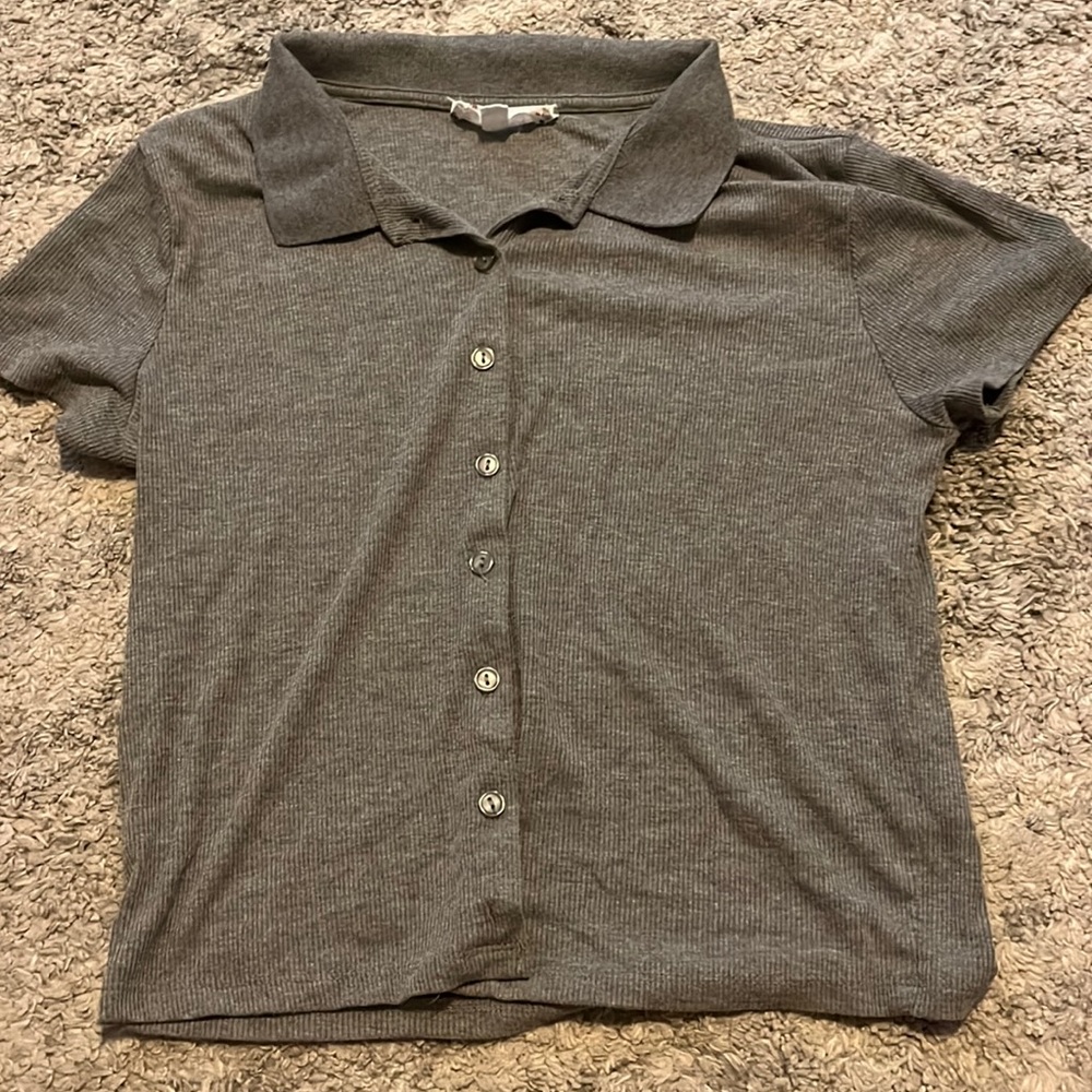 Grey button down short sleeve shirt with collar. Slightly worn.